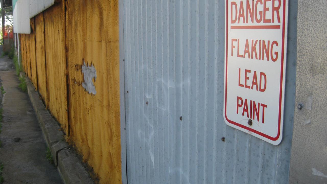 Flake paint wall with danger sign attached