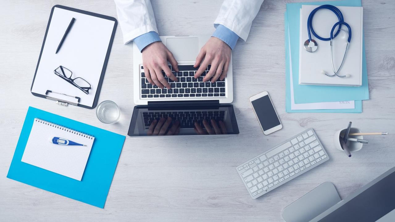 Medical desk with laptop and charts