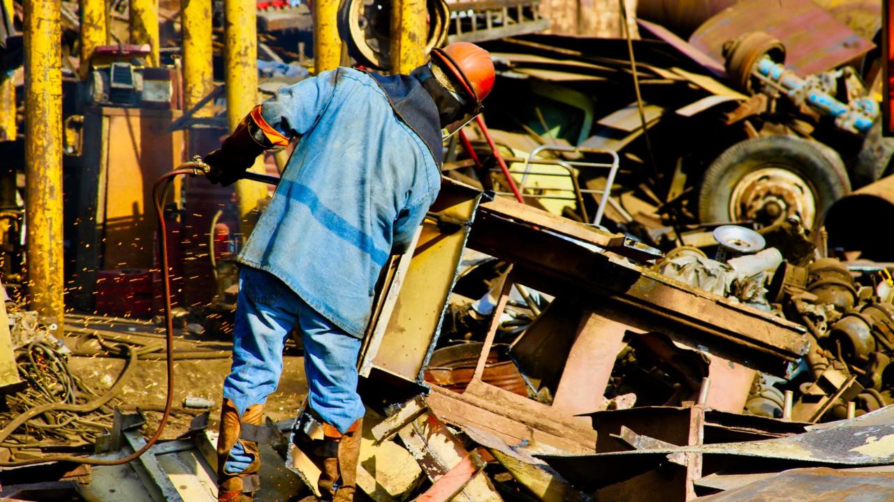 Man working in metal scrap yard