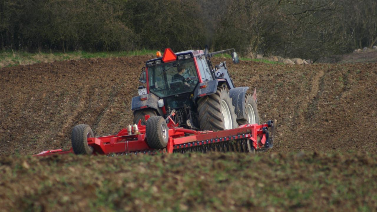 Red tractor working in a field