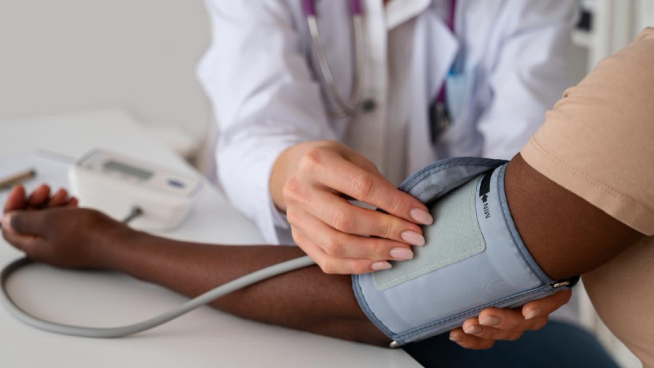 Doctor checking patient blood pressure