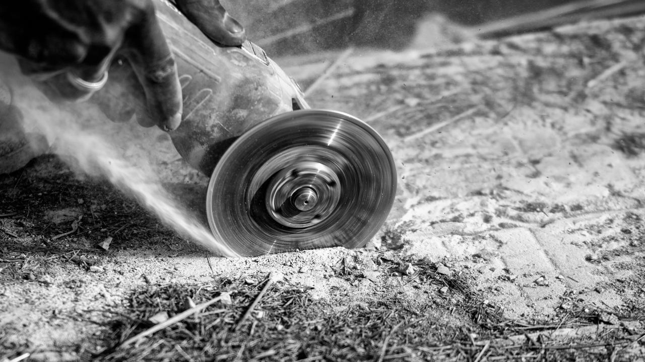 Person cutting stone with electrical tool