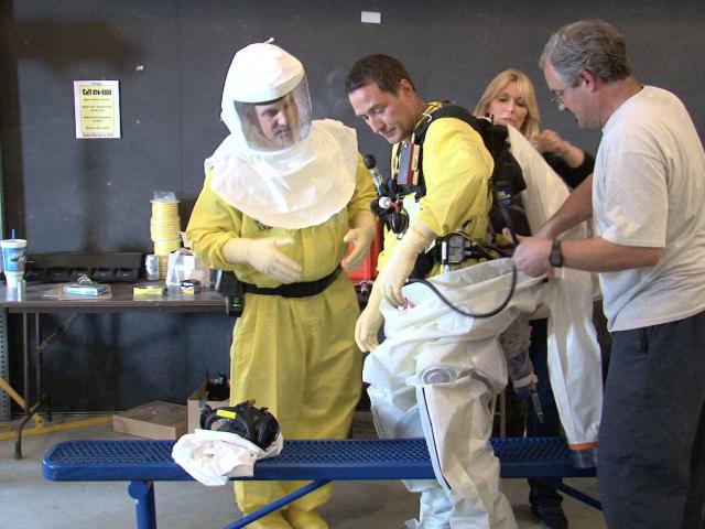 Industrial workers wearing PAPR respirators