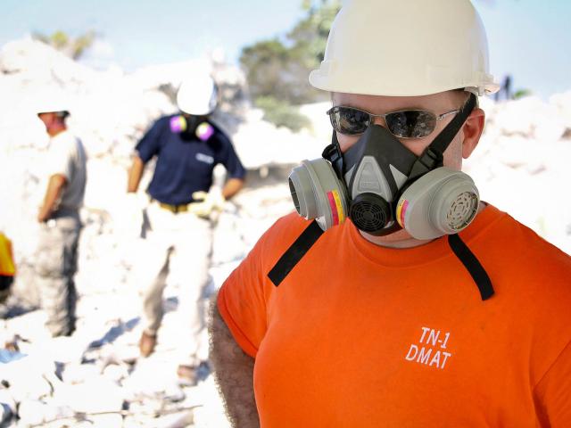 Outdoor worker wearing half face respirator