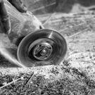 Person cutting stone with electrical tool