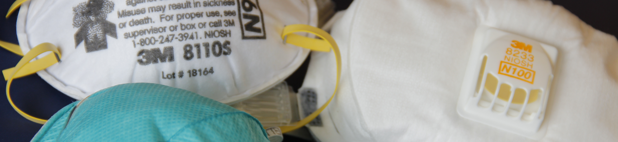 Three N95 masks on a flat surface