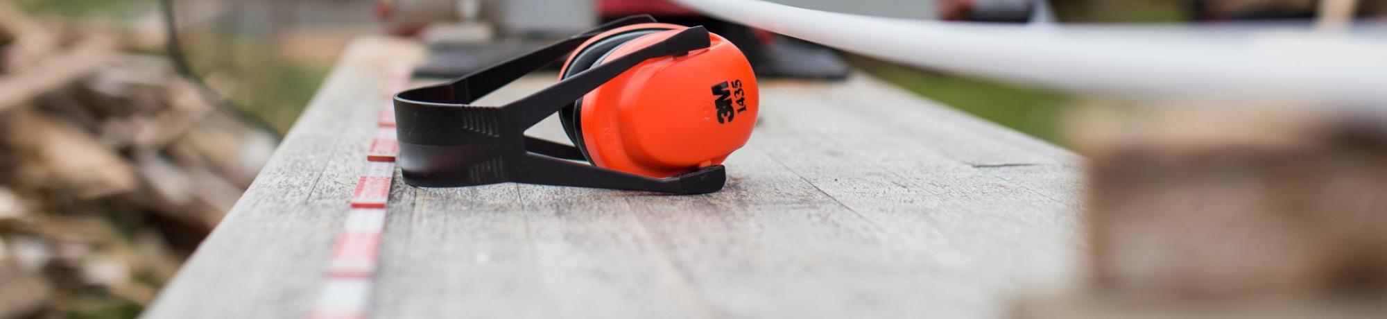 Noise cancelling headphones next to table saw