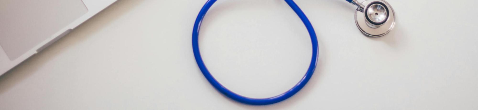 Stethoscope next to laptop
